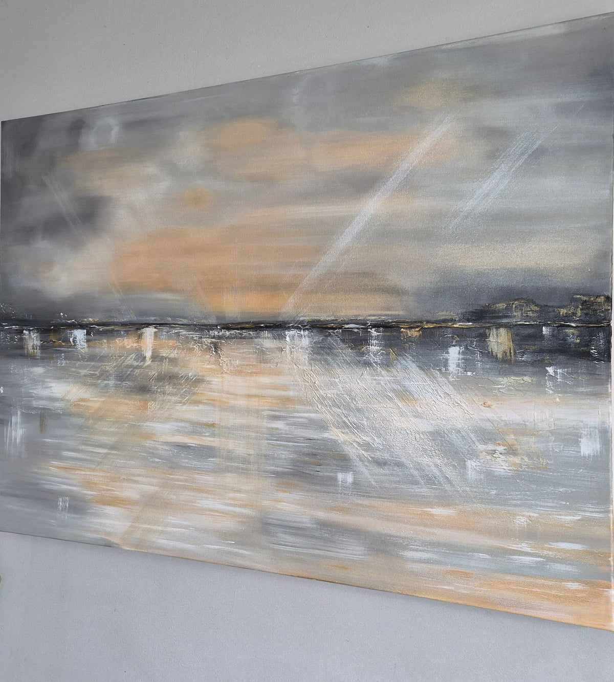 An abstract landscape painting on canvas, featuring a cloudy sky in shades of gray, white, and warm beige, with a reflective water scene below.