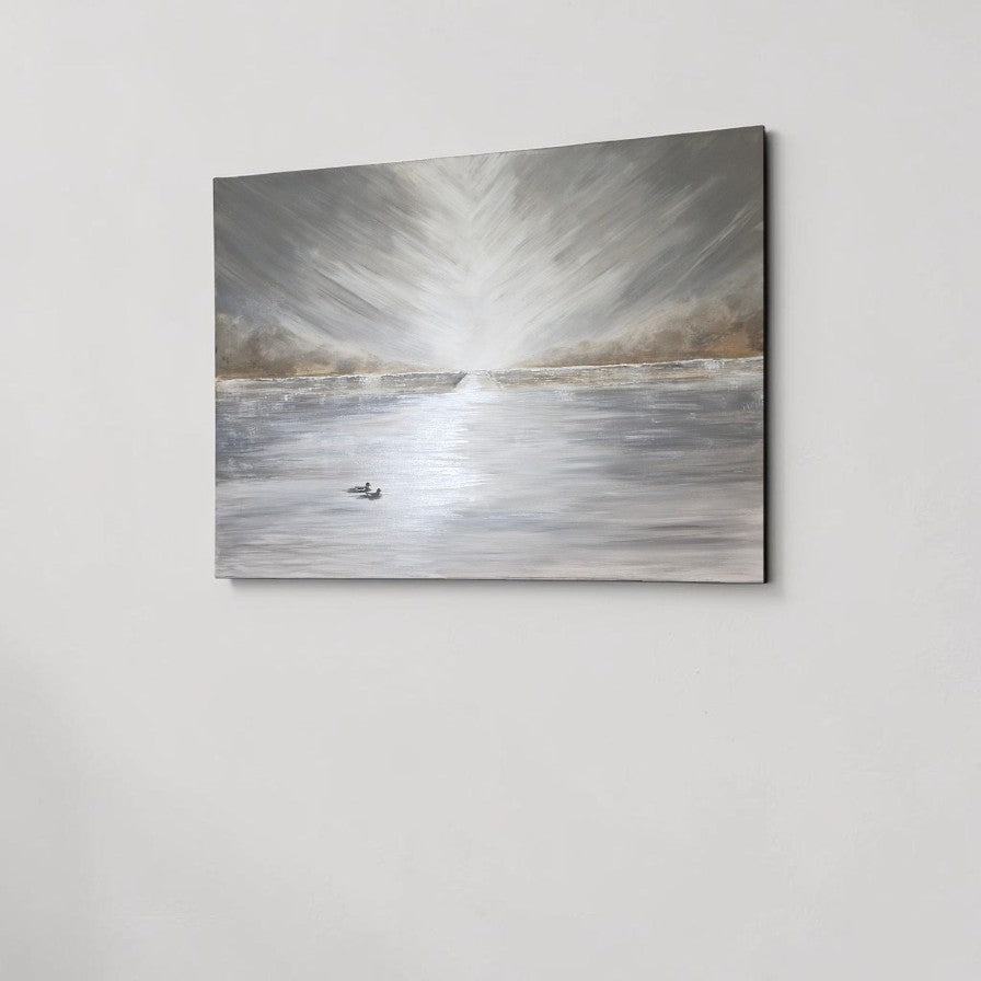 A square canvas wall art print depicting a serene, abstract landscape with a bright sunburst over a reflective body of water, shown hanging on a light gray wall.